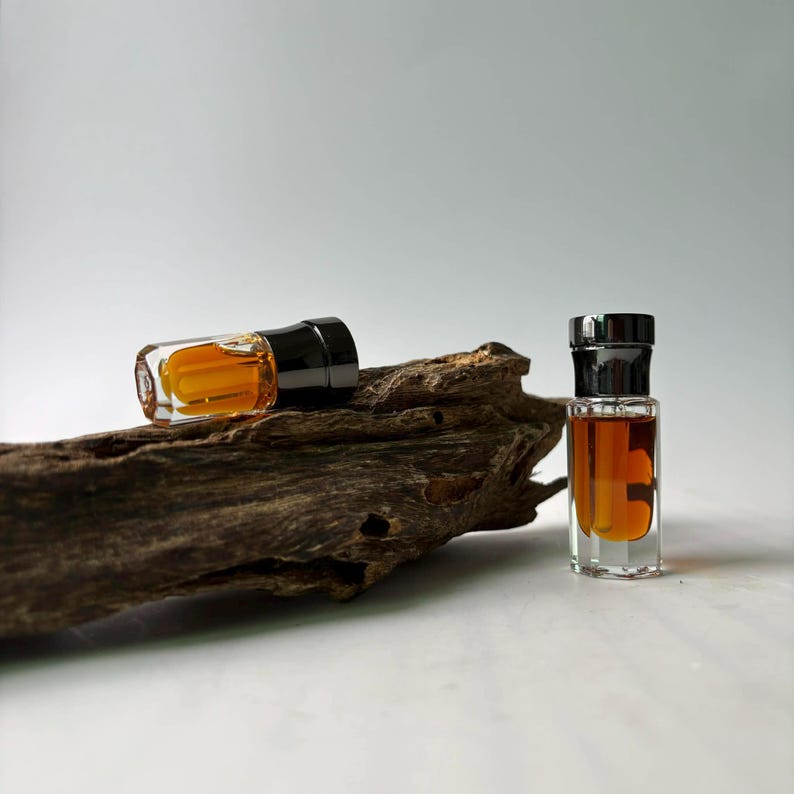 Hainan Insect Oud Oil bottles on driftwood